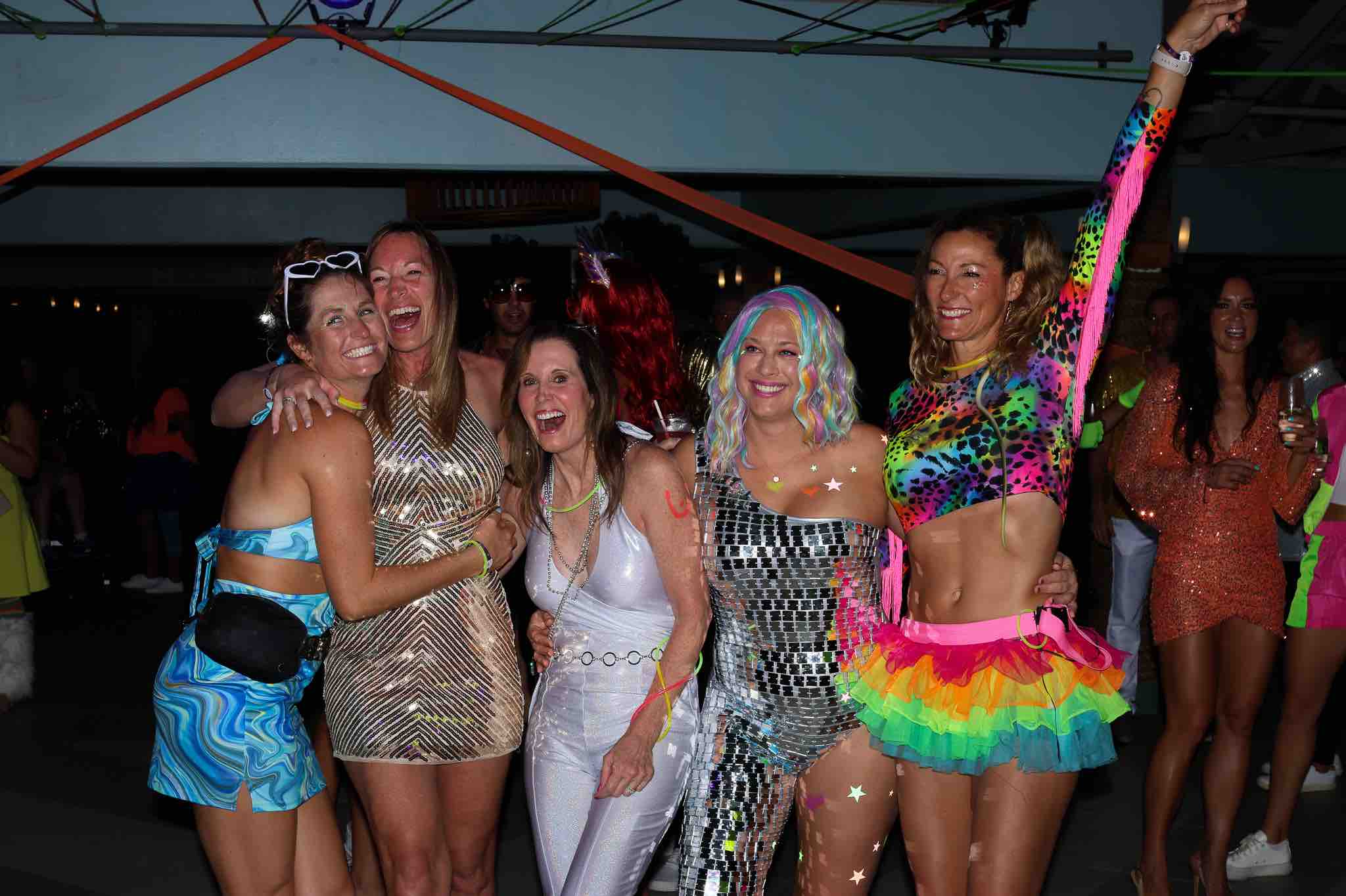 Women at Volleyball Vacations in Disco theme outfits having fun